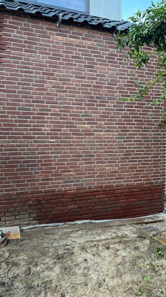 Overzicht van de gevel met minerale steenstrips bij het woonhuis in Langedijk